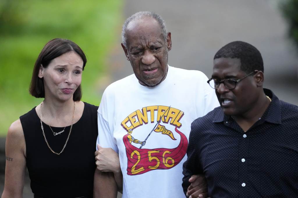 Bill Cosby Bill Cosby, center, and spokesperson Andrew Wyatt, right, approach members of the media