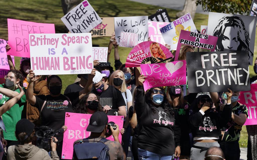 Britney Spears fans hold signs outside a court hearing