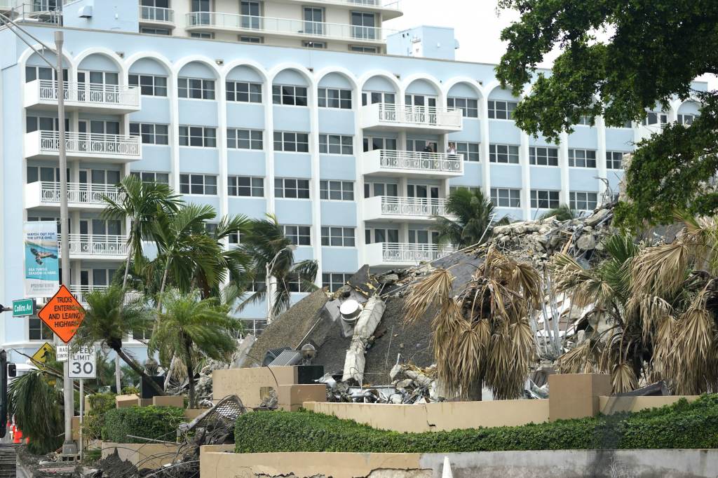 Building Collapse Miami People look out from a balcony onto the collapsed and subsequently demolished Champlain Towers South condominium building
