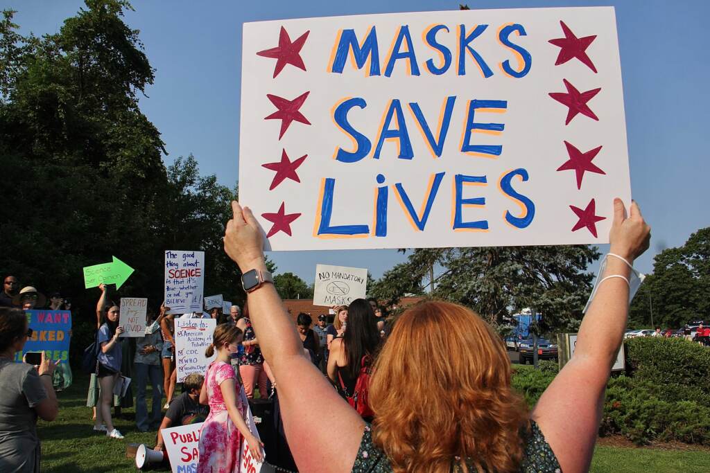 Image from iOS (137) Parents gather outside a Central Bucks school board meeting to protest or defend the board’s decision to open schools in the fall without requiring protective face masks. (Emma Lee/WHYY)