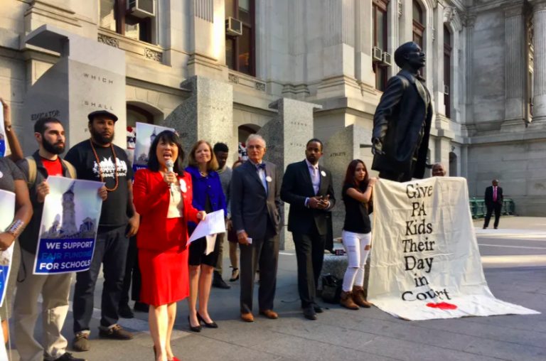 Before Philadelphia’s City Hall, plaintiffs and their attorneys celebrate an earlier court ruling allowing their fair funding case to proceed. (Darryl Murphy / The Notebook)