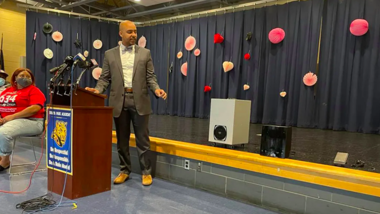 School District of Philadelphia Chief Operating Officer Reggie McNeil points to the district’s new air and surface purifiers. Thursday’s announcement was made at Juniata Park Academy in the lower Northeast. (Johann Calhoun / Chalkbeat)