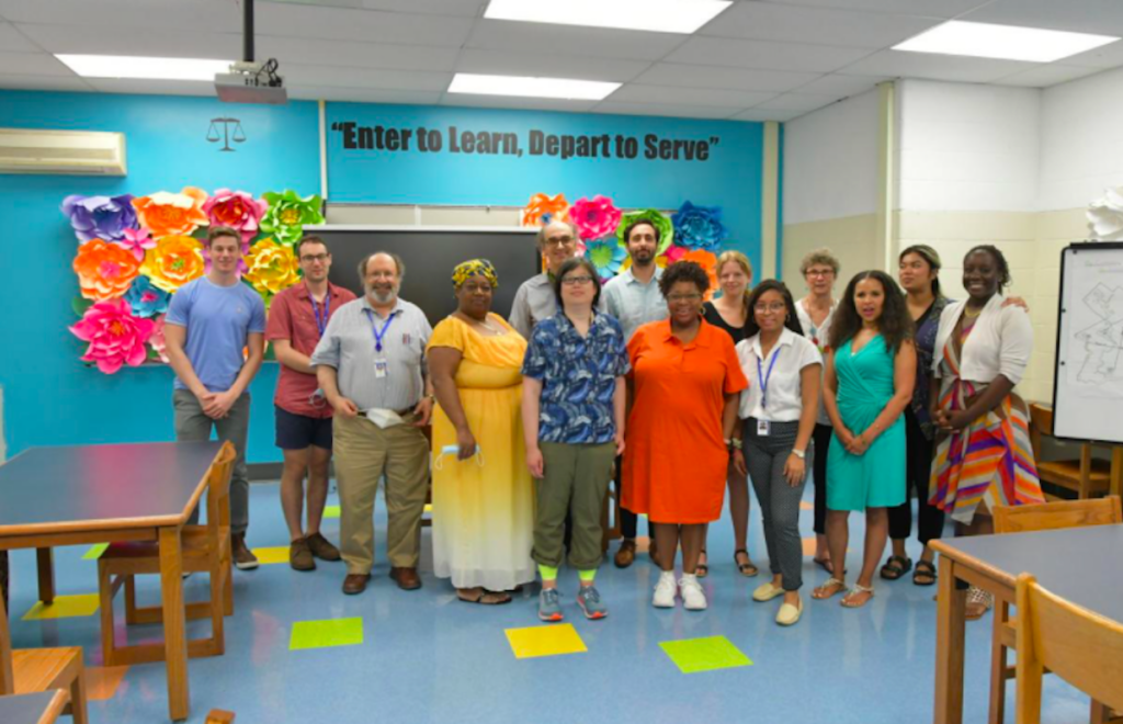 Screen Shot 2021-07-24 at 2.57.56 PM Donna Frisby-Greenwood, center in orange, stands with members of The Fund and Bethune Principal Aliya Cantanch Bradley at the Mary McLeod Bethune School. (Tribune Photo/Abdul R. Sulayman)