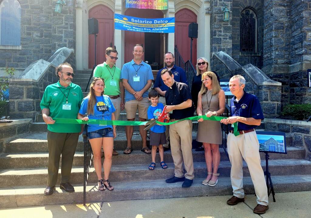 Solarize Delco 1 ribbon cutting Solarize Delco's ribbon cutting. Left to Right:
Peter Puglionesi, Melisa Romano, and Noel Smyth of Solarize Delco; Mike Zabel State Representative; Pastor Tim Johansen with son Leo; Colin Quinn VP Haverford Board of Commissioners; Francine Locke Del. Co. Director of Sustainability; Elaine Schaefer Del. Co. Council, Gerald Hart President Haverford Board of Commissioners. (Courtesy of Delaware County/Adrienne Marofsky)