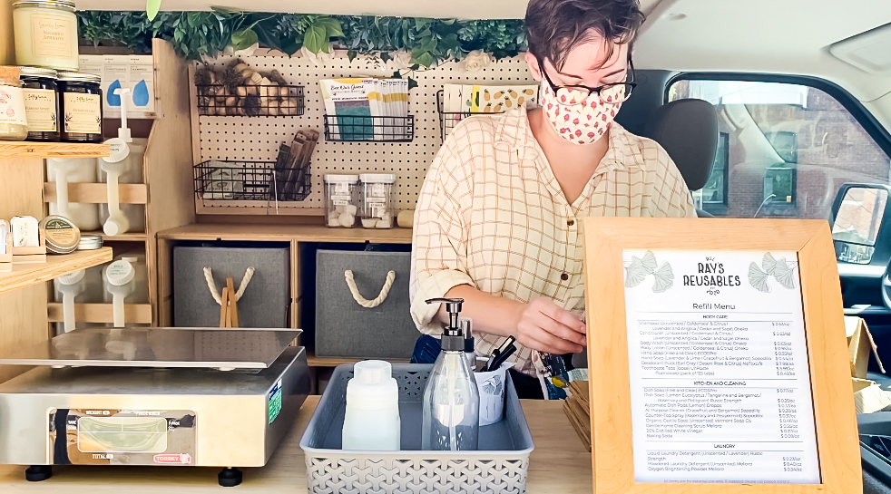 A cashier working at Ray's Reusables, a mobile unit that sells local goods