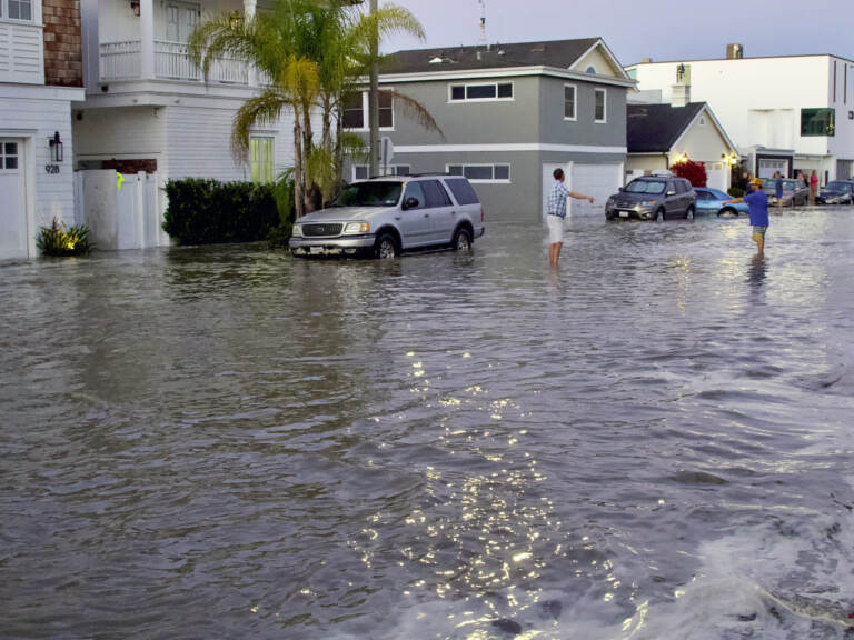 Streets and homes flooded in Newport Beach, Calif., during a high tide in July 2020. So-called sunny day floods are getting more common in coastal cities and towns as sea levels rise due to climate change. (Matt Hartman/AP)