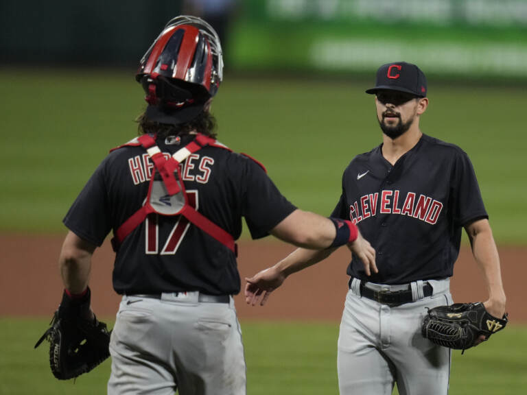 Cleveland relief pitcher Nick Sandlin (right) and catcher Austin Hedges celebrate a 10-1 victory over the St. Louis Cardinals on June 8, 2021, in St. Louis. On Friday, the Cleveland team announced its new name, the Guardians. (Jeff Roberson/AP)