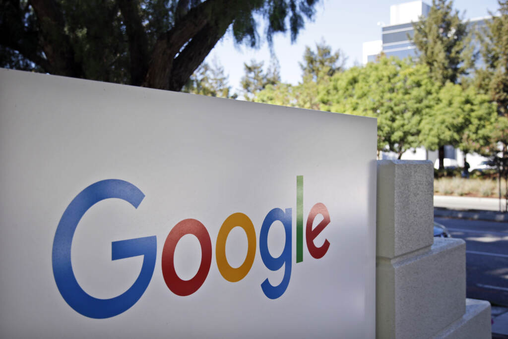 Google said Wednesday it would require its U.S. employees to be vaccinated before coming to work. Facebook followed suit shortly afterward with a similar announcement. A Google sign is seen outside the company's headquarters