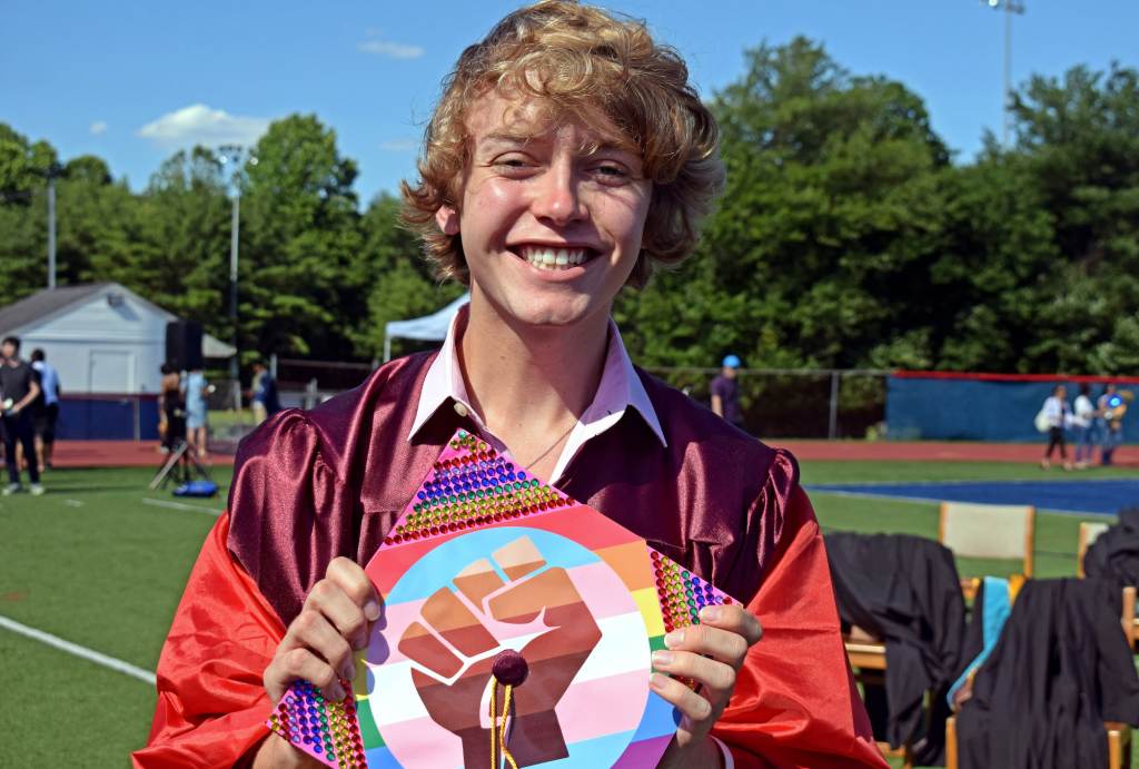 bryce05 Bryce Dershem holds up his graduation cap, which features a fist on top of a trans pride flag