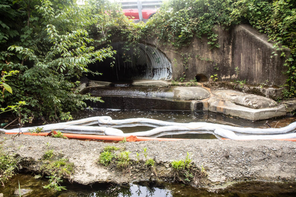 delco_oil_spill_KP_072721_02 An oil spill cleanup sock in a small waterway leading to Chester Creek