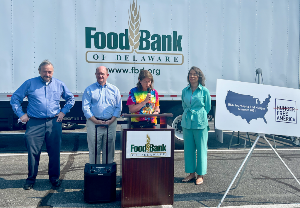 foodbank1 Hunger Free America CEO Joel Berg (left) joins U.S. Sen. Chris Coons, Food Bank of Delaware president Cathy Kanefsky and Delaware Congresswoman Lisa Blunt Rochester at a food distribution event in Georgetown Tuesday morning. (Johnny Perez-Gonzalez / WHYY)