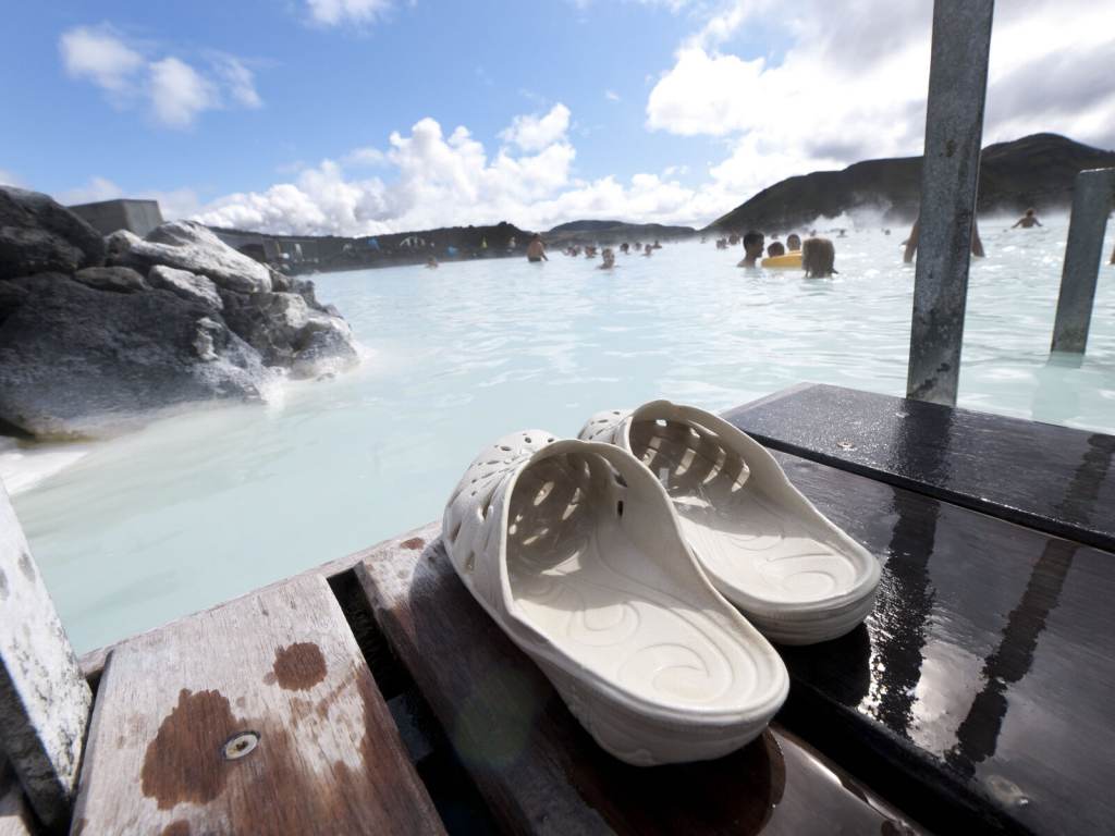 FILES-ICELAND-CANADA-ENERGY-TAKEOVER-PEOPLE-BJORK A pair of sandals are pictured in the foreground, with Blue Lagoon in the background