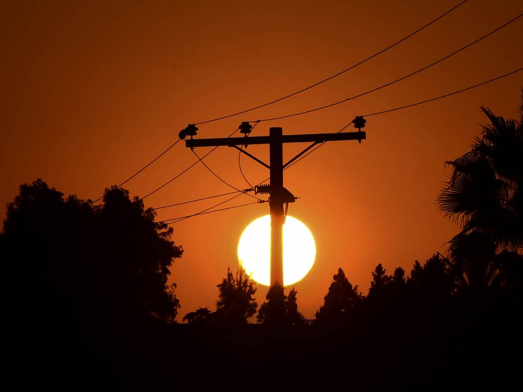 The sun sets behind power lines in Los Angeles in September. The sun sets behind power lines in Los Angeles in September.
(Frederic J. Brown/AFP via Getty Images)