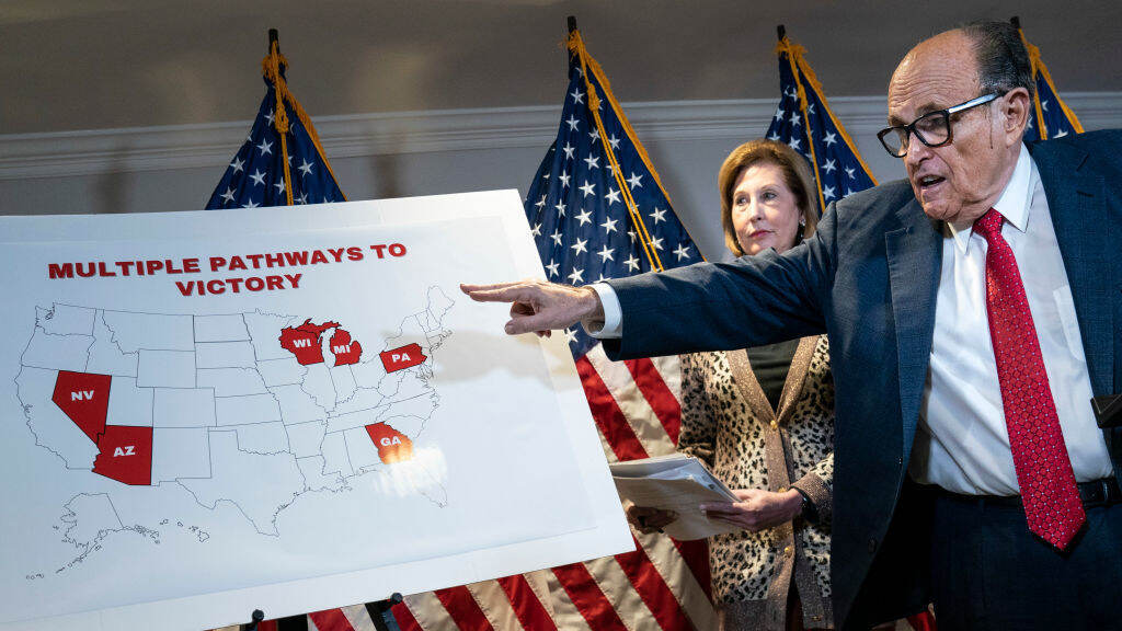 Rudy Giuliani points to a map as he speaks to the press about various lawsuits related to the 2020 election on Nov. 19, 2020. He and other Trump lawyers are now under scrutiny for their roles in promoting false claims of election fraud. Rudy Giuliani points to a map as he speaks to the press about various lawsuits related to the 2020 election on Nov. 19, 2020. He and other Trump lawyers are now under scrutiny for their roles in promoting false claims of election fraud. (Drew Angerer/Getty Images)
