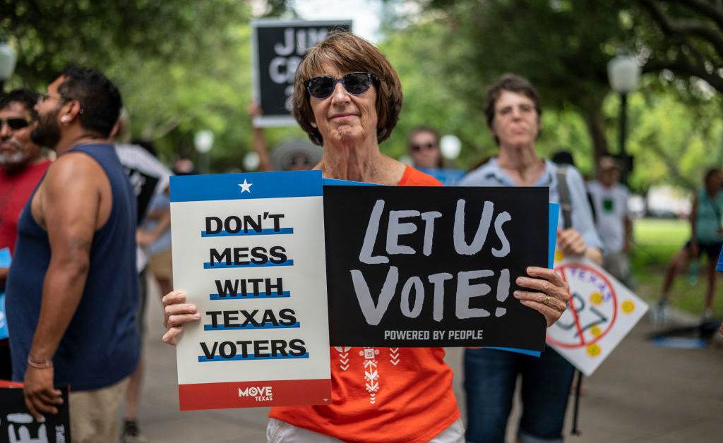 A woman holds signs at a rally at the state Capitol on June 20 in Austin, Texas, to fight SB7, a controversial voting bill. A woman holds signs at a rally at the state Capitol on June 20 in Austin, Texas, to fight SB7, a controversial voting bill. (Sergio Flores/Getty Images)