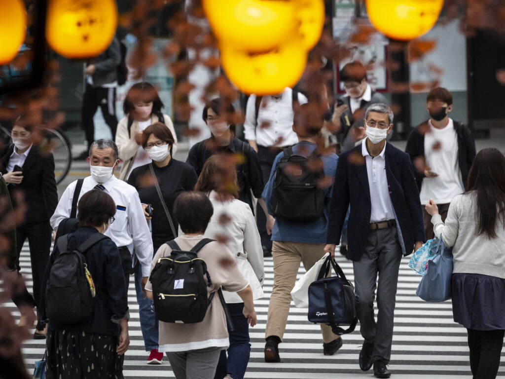 People in Tokyo wear masks on May 7. Daily coronavirus infections in Japan’s capital have topped 4,000 — nearly four times as many as a week ago. People in Tokyo wear masks on May 7. Daily coronavirus infections in Japan's capital have topped 4,000 — nearly four times as many as a week ago. (Yuichi Yamazaki/Getty Images)