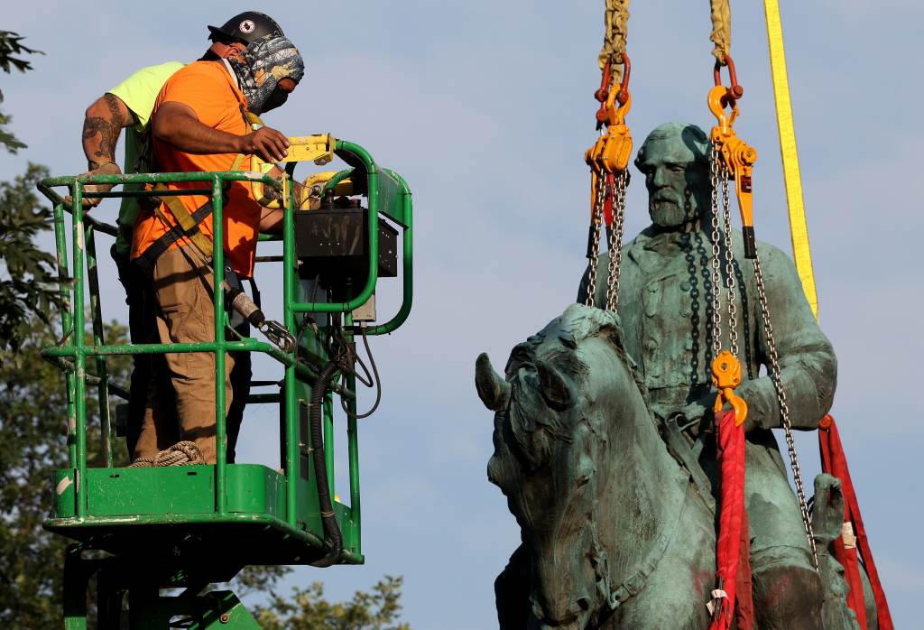 Workers remove a statue of Confederate Gen. Robert E. Lee from Market Street Park on Saturday in Charlottesville, Va. Workers remove a statue of Confederate Gen. Robert E. Lee from Market Street Park on Saturday in Charlottesville, Va. (Win McNamee/Getty Images)