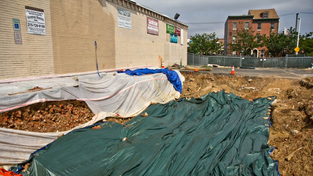 graves-construction-nolibs-01crop Residents are speculating that a torn up parking lot at 5th and Spring Garden Streets in Philadelphia is a grave sit in the midst of excavation. (Kimberly Paynter/WHYY)