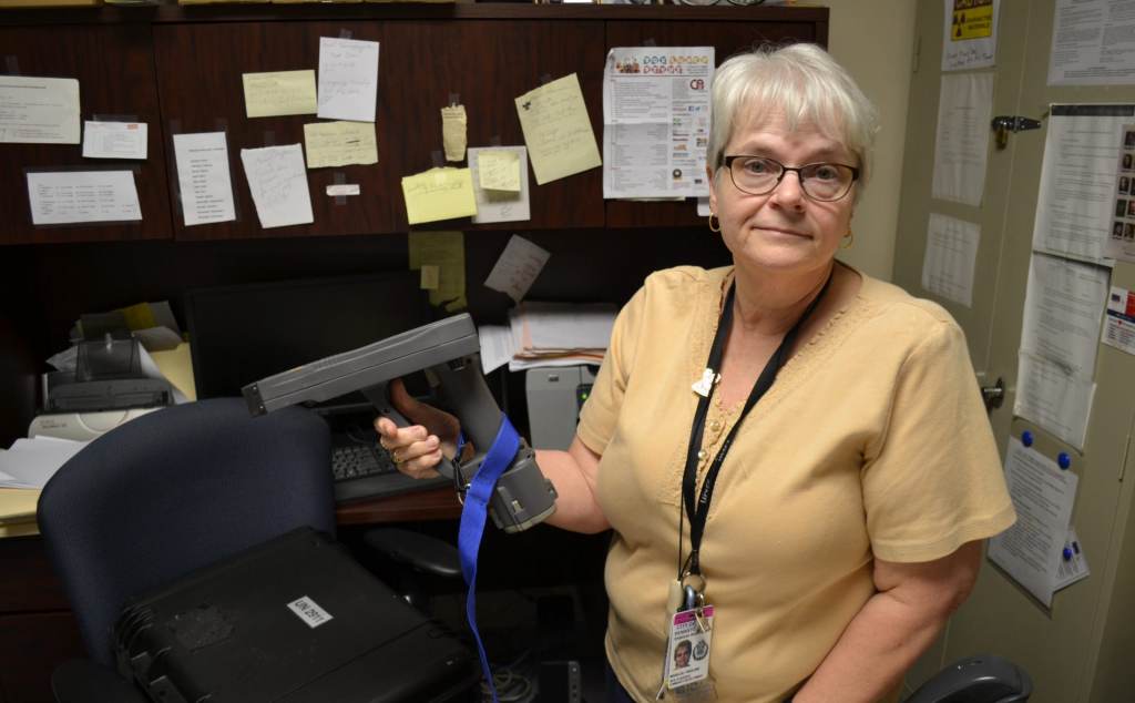 Marilou Yingling holds an x-ray fluorescent 