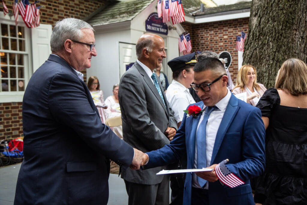 Gonzalo Ramirez shakes hands with Mayor Jim Kenney