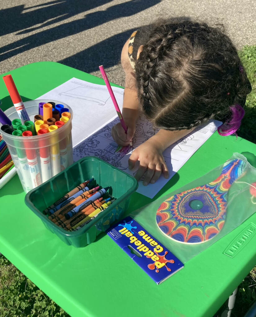 A child colors in the Seedlings coloring book.