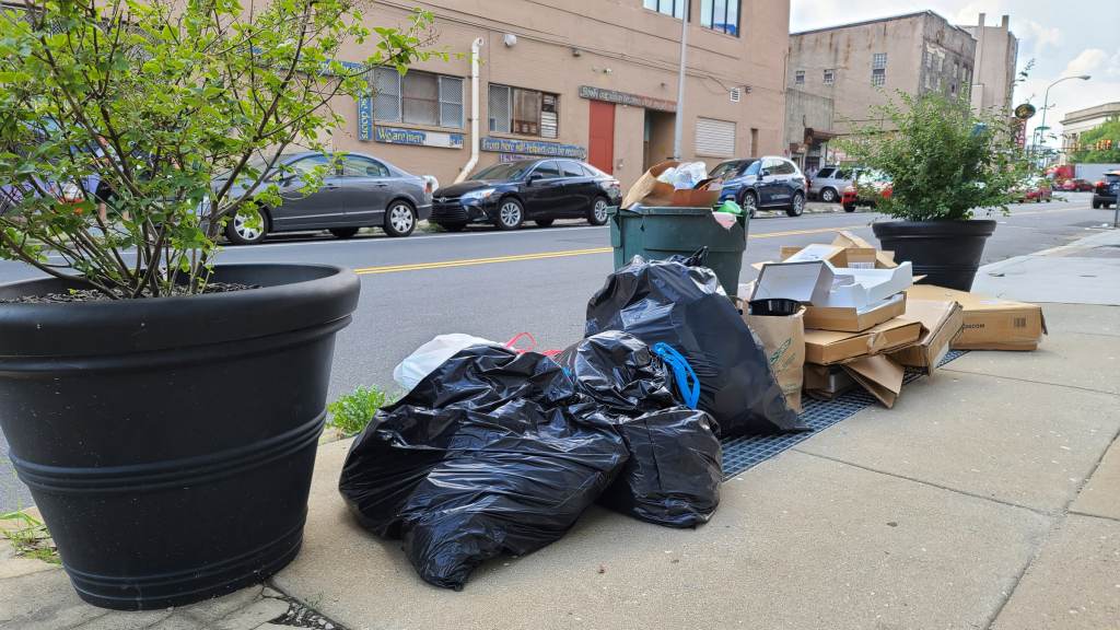Trash sits on a Philly sidewalk.