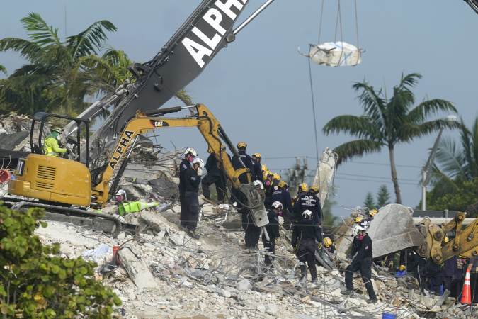 Rescue crews work at the site of the collapsed Champlain Towers South condo building