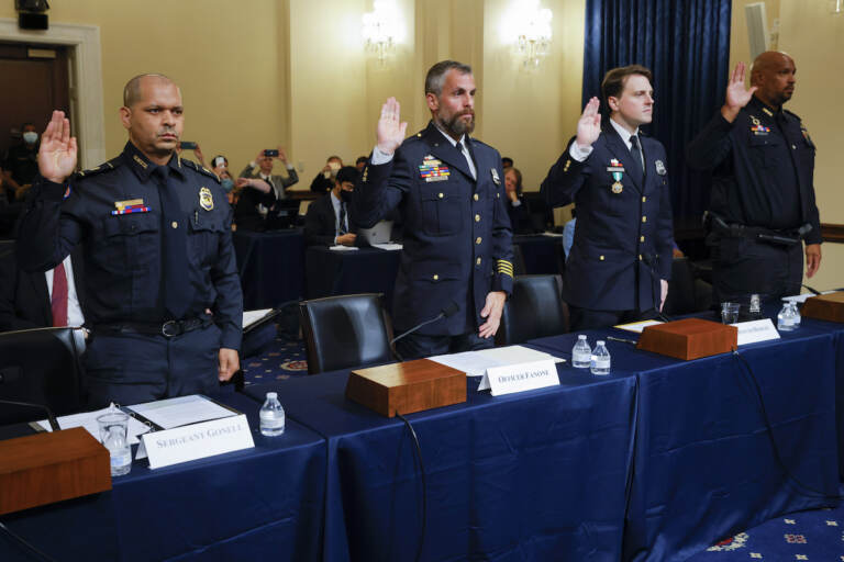 U.S. Capitol Police sergeant Aquilino Gonell; Washington DC Metropolitan Police Department officers Michael Fanone and Daniel Hodges, and U.S. Capitol Police Officer Harry Dunn are sworn in to testify during the opening hearing of the U.S. House (Select) Committee investigating the January 6 attack on the U.S. Capitol, on Capitol Hill in Washington, U.S., July 27, 2021. REUTERS/Jim Bourg/Pool