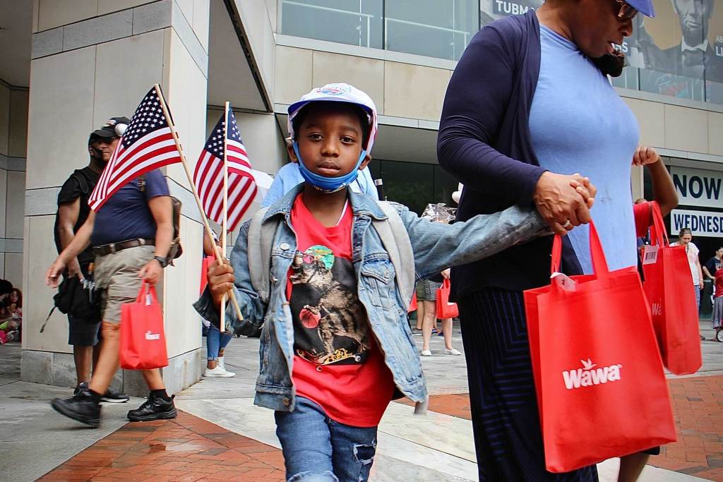 wawa_hoagie_day_EL_70121_01 Naeem Townsend leaves the National Constitution Center with a hat, a flag, and a hoagie, giveaways