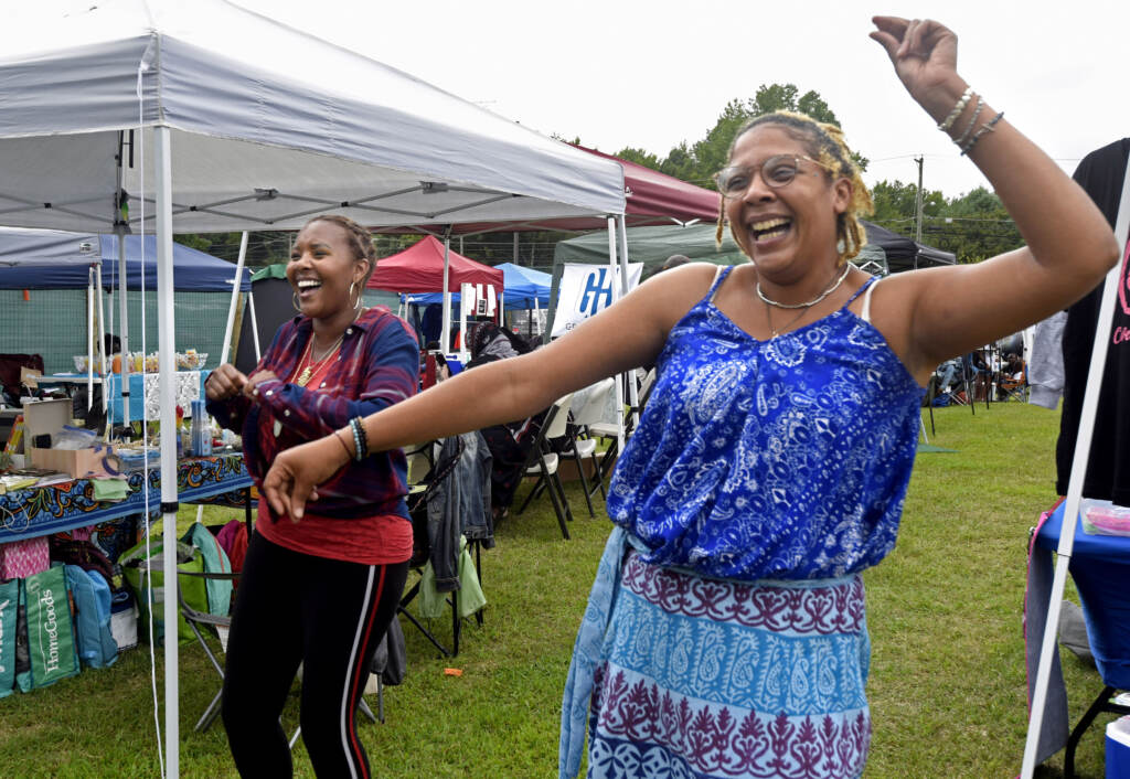 Two people pose at grand opening of Mask Melanin Market in Glassboro.