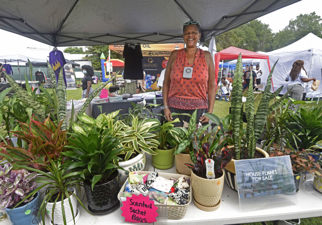 Vendor stands at booth at grand opening of Mask Melanin Market in Glassboro, NJ.