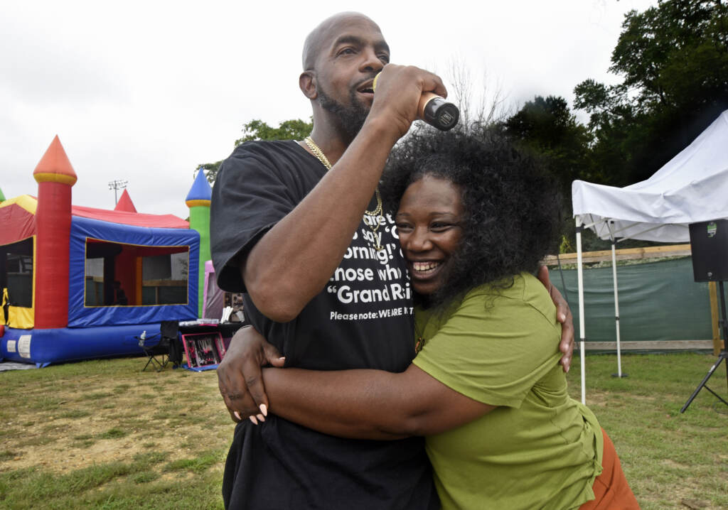 Two people address crowd at Mask Melanin Market.