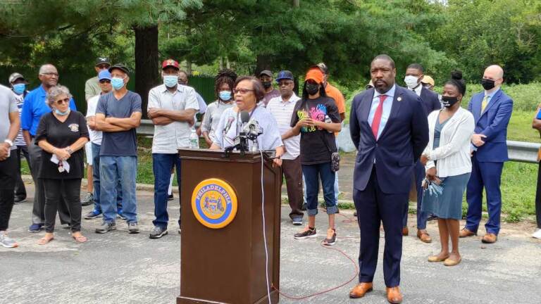 Carolyn Mosley of the Eastwick United Community Development Corp speaks at rally. (Tom MacDonald/WHYY)