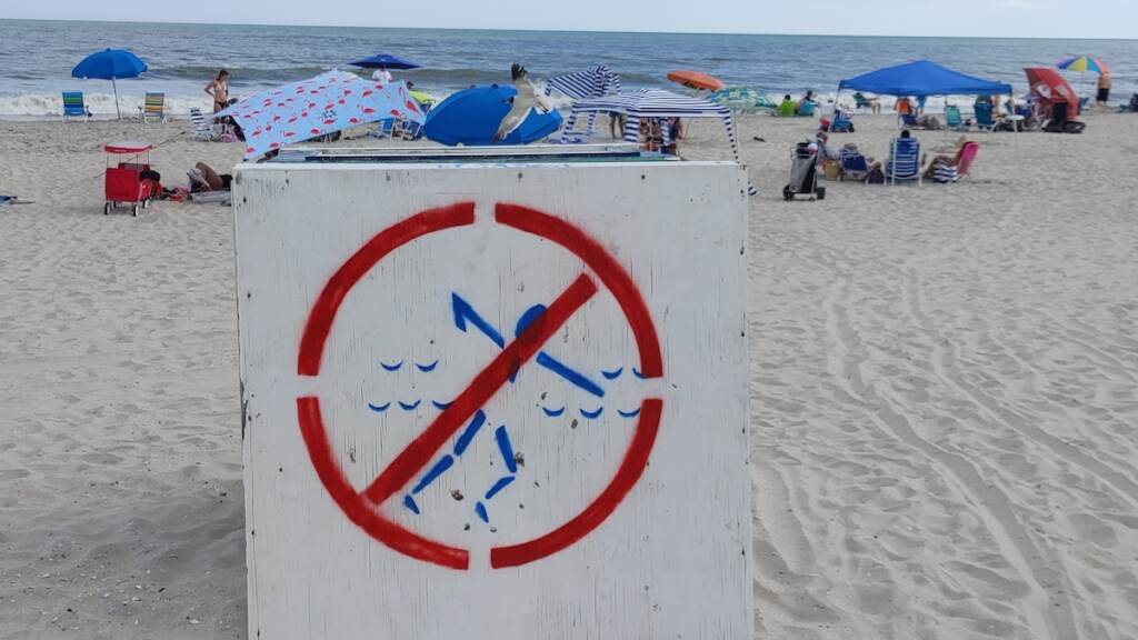 0819211550d An overturned lifeguard stand warns swimmers that the Park Place beach in Ocean City, New Jersey is unguarded because of a staffing shortage. (Tom MacDonald/WHYY)