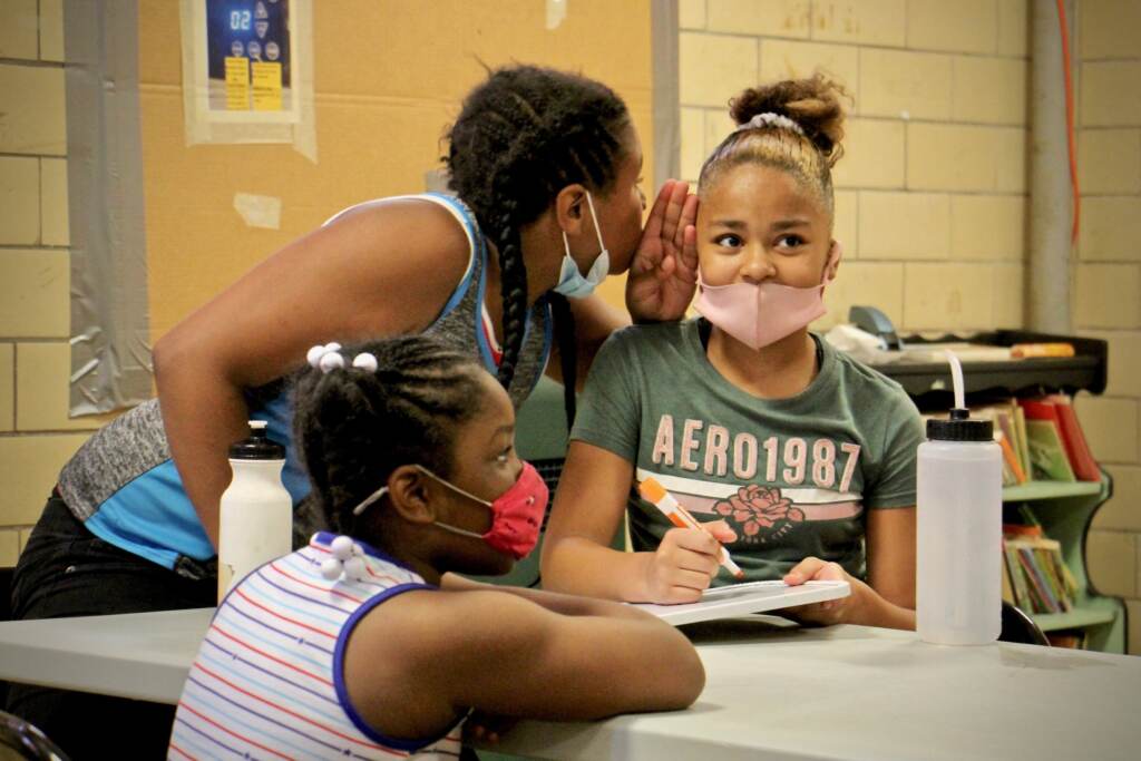 2021 07 30-e lee-jaydalee rivera vanessa irrizary-philadelphia mcveigh rec center-enhanced literacy Jaydalee Rivera whispers a suggestion to Vanessa Irrizary