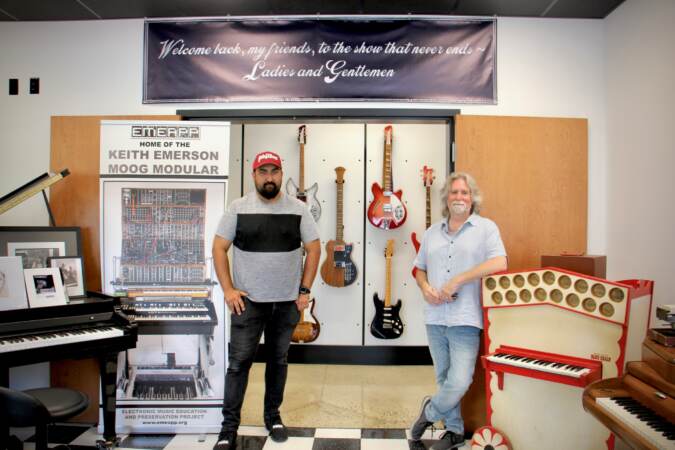 Vince Pupilio Jr. (left) and Drew Raison stand inside the Electronic Music Education and Preservation Project museum
