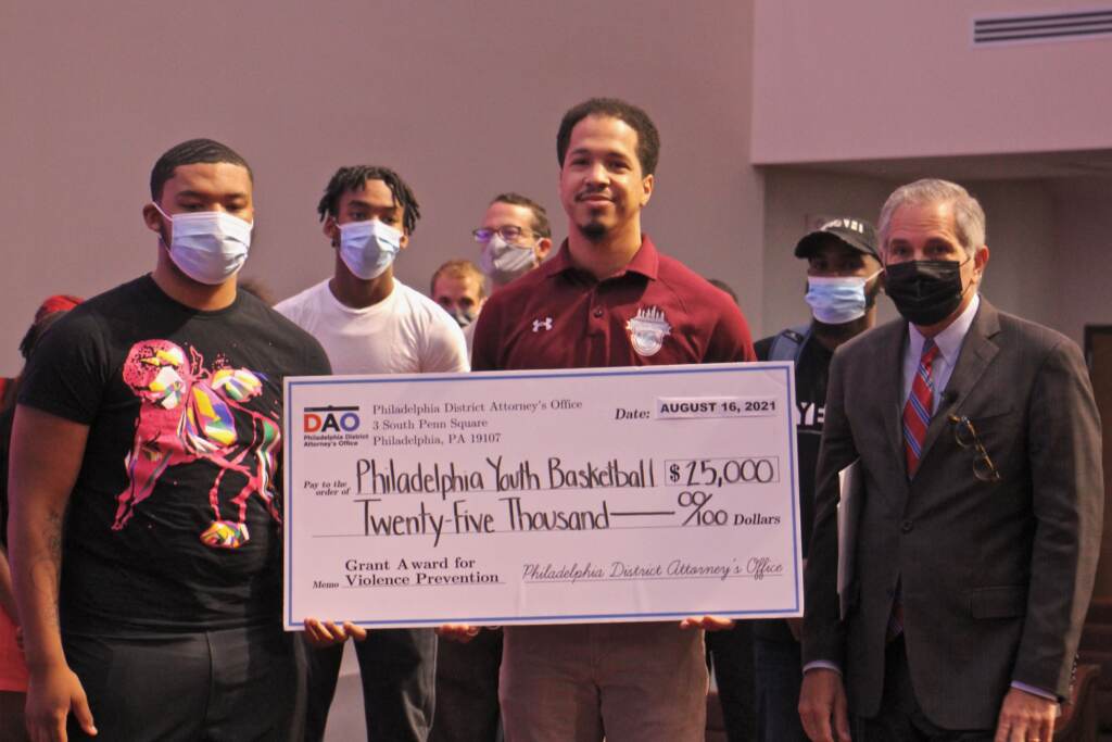 Lymere Mapp (left) and Kyle Lafferty hold a check for $25,000