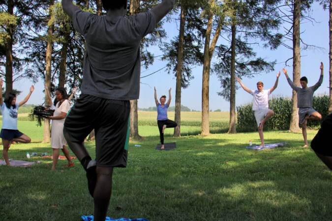 Students participate in an outdoor yoga class