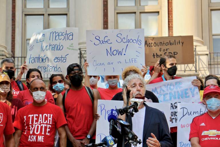 Teachers, parents and staff at the Masterman School gather on the steps of the school to voice their concerns about unsafe conditions in the building