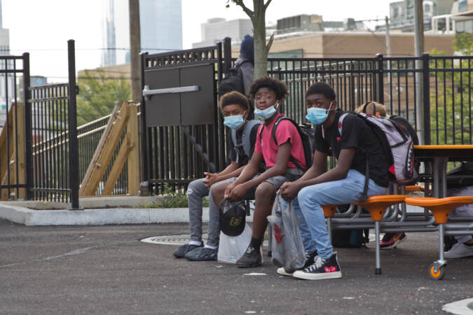 Students wear face masks outside of their school in Philly
