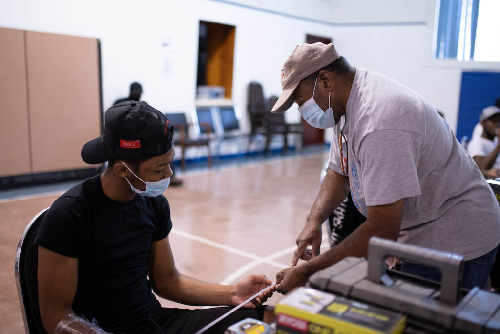 20210810_WHYY_Carpentry Academy_D850_19420 Saif Ashshaheed, 17, reviews reviews how to use a ruler with instructor Greg Palmer at the Dixon House community center in South Philadelphia on Tuesday, August 11, 2021. (Kriston Jae Bethel for WHYY)