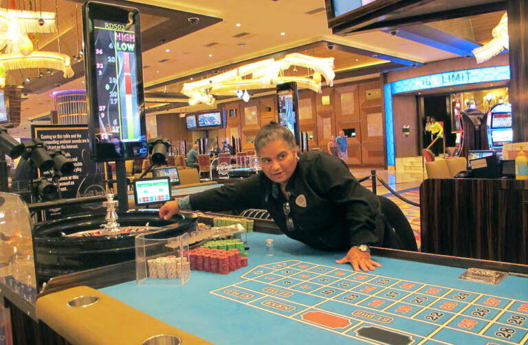 This June 28, 2021 photo shows a dealer at the Hard Rock casino in Atlantic City NJ conducting a game of roulette. Figures released Aug. 10, 2021 by the American Gaming Association show the nation's commercial casinos had their best second quarter in history, with $13.6 billion in revenue, and are on pace to have their best year ever in 2021 as gamblers return to in-person casinos. (AP Photo/Wayne Parry)