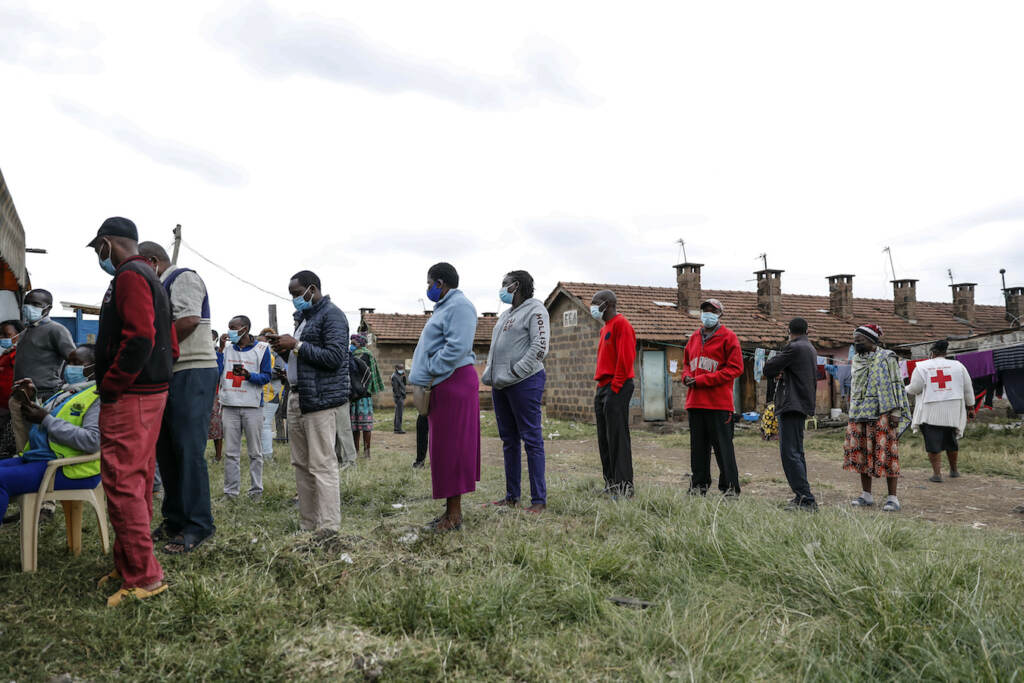 Virus Outbreak Donation Dependency Kenya Kenyans queue to receive AstraZeneca coronavirus vaccine donated by Britain, at the Makongeni Estate in Nairobi, Kenya Saturday, Aug. 14, 2021. An international system to share coronavirus vaccines was supposed to guarantee that low and middle-income countries could get doses without being last in line and at the mercy of unreliable donations but it hasn't worked out that way and in late June alone, the initiative known as COVAX sent some 530,000 doses to Britain – more than double the amount sent that month to the entire continent of Africa. (AP Photo/Brian Inganga)