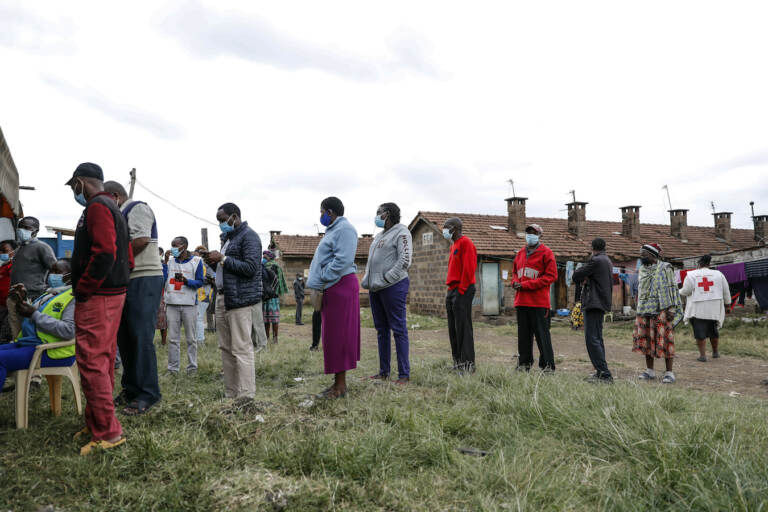 Kenyans queue to receive AstraZeneca coronavirus vaccine donated by Britain, at the Makongeni Estate in Nairobi, Kenya Saturday, Aug. 14, 2021. An international system to share coronavirus vaccines was supposed to guarantee that low and middle-income countries could get doses without being last in line and at the mercy of unreliable donations but it hasn't worked out that way and in late June alone, the initiative known as COVAX sent some 530,000 doses to Britain – more than double the amount sent that month to the entire continent of Africa. (AP Photo/Brian Inganga)