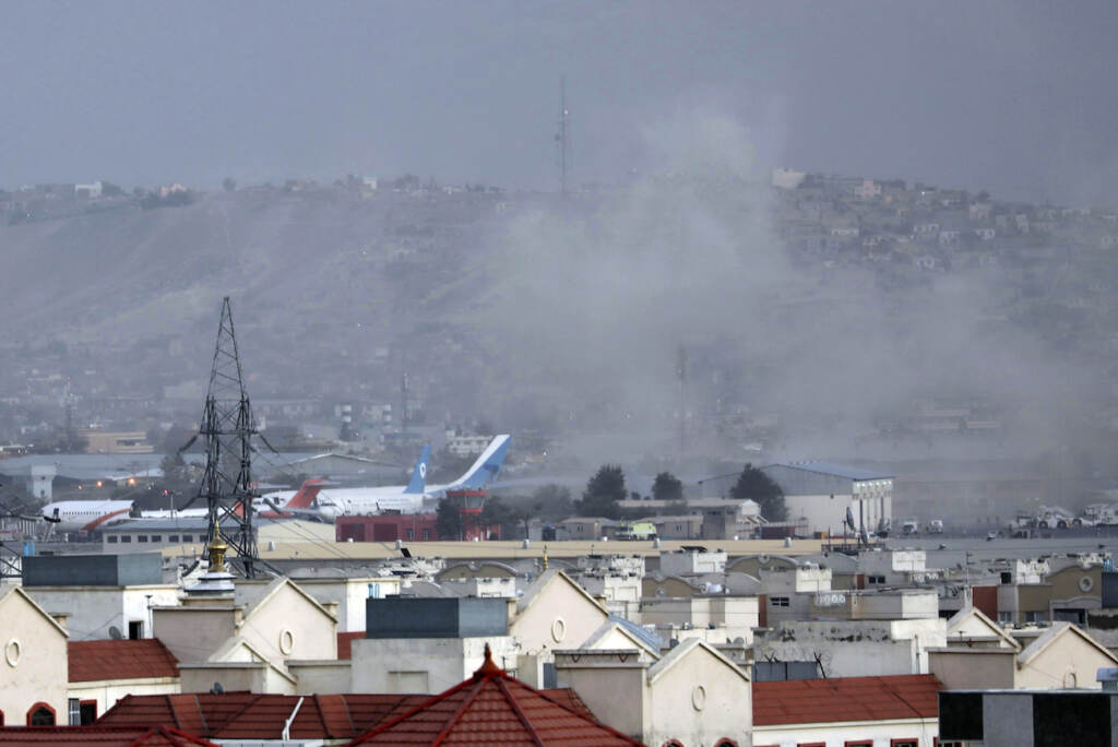 Afghanistan Smoke rises from a deadly explosion outside the airport in Kabul, Afghanistan, Thursday, Aug. 26, 2021. Two suicide bombers and gunmen have targeted crowds massing near the Kabul airport, in the waning days of a massive airlift that has drawn thousands of people seeking to flee the Taliban takeover of Afghanistan. (AP Photo/Wali Sabawoon)