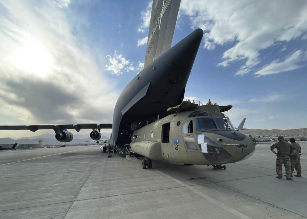 US Afghanistan In this image provided by the Department of Defense, a CH-47 Chinook from the 82nd Combat Aviation Brigade, 82nd Airborne Division is loaded onto a U.S. Air Force C-17 Globemaster III at Hamid Karzai International Airport in Kabul, Afghanistan, Saturday, Aug, 28, 2021. (Department of Defense via AP)