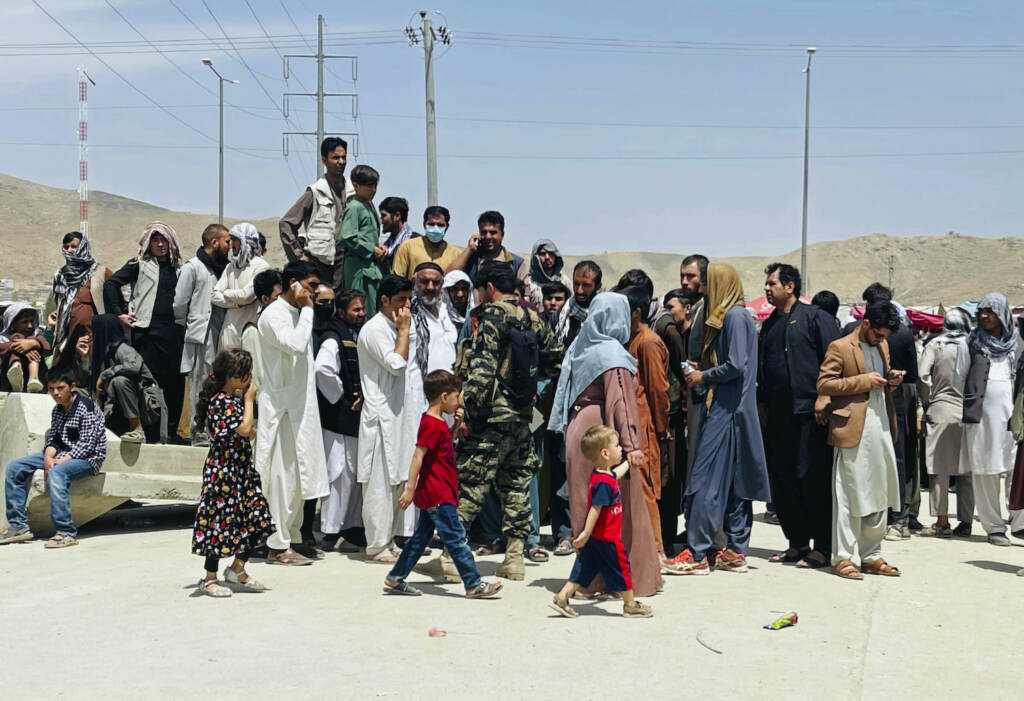 Hundreds of people gather near the international airport in Kabul