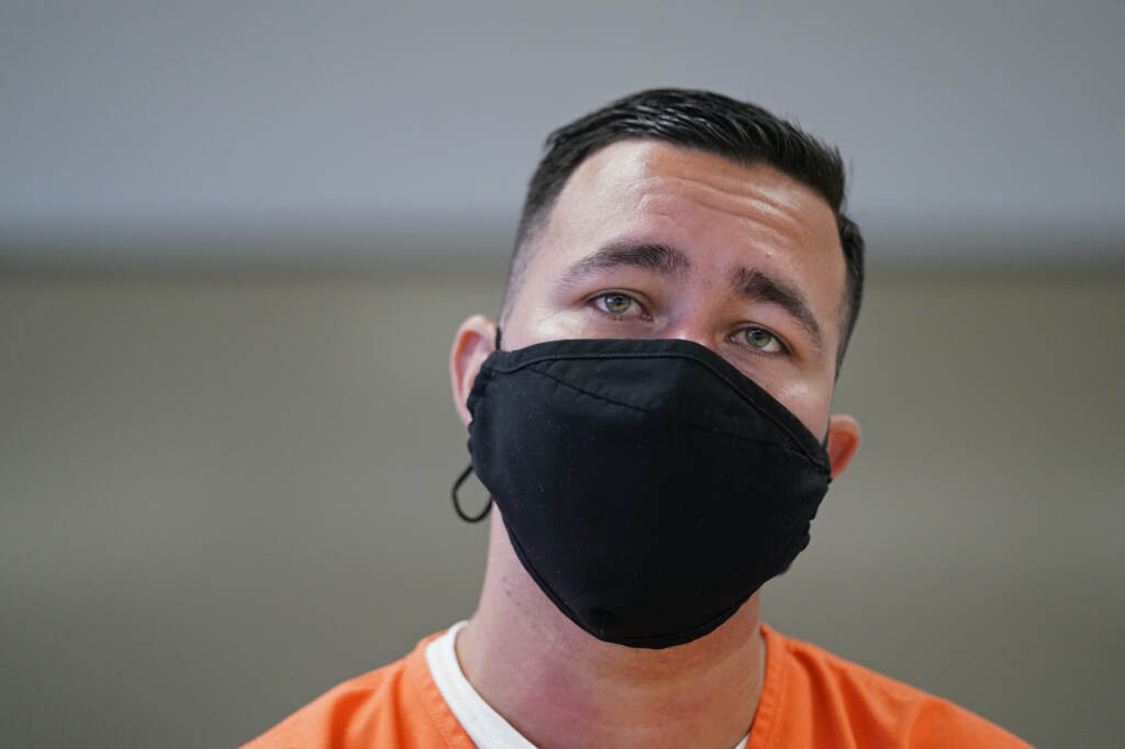 Immigration ICE Detentions Alexander Martinez wears a face mask and detainee scrubs