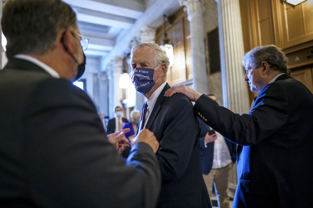 Sen. Angus King, center, speaks with Sen. Gary Peters, left, while Sen. John Kennedy walks by at right