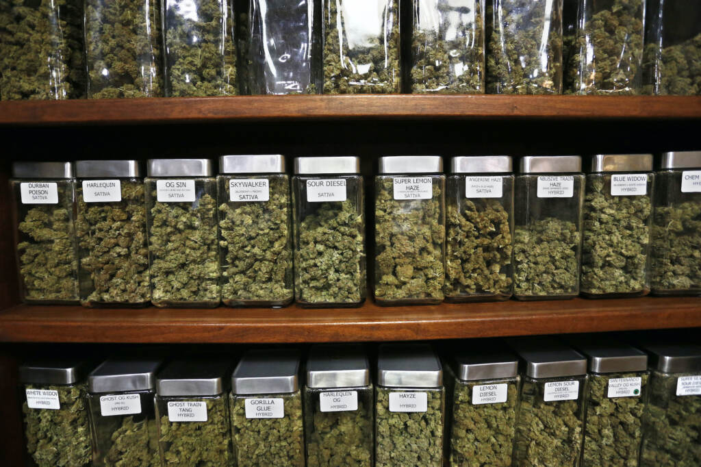 US Marijuana Glass containers display varieties of marijuana for sale on shelves